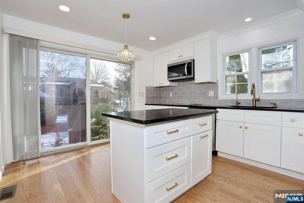 31 Madison Avenue Demarest, NJ 07627 - Photo 10 of 50 a kitchen with granite countertop white cabinets and a large window