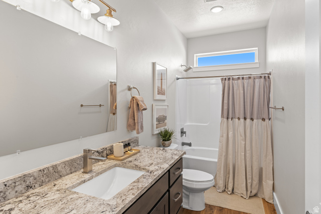 1343 North Trapper Loop Garden City, UT 84028 - Photo 8 of 56 Full bath with vanity, shower / bath combination with curtain, a textured ceiling, and dark wood-style flooring