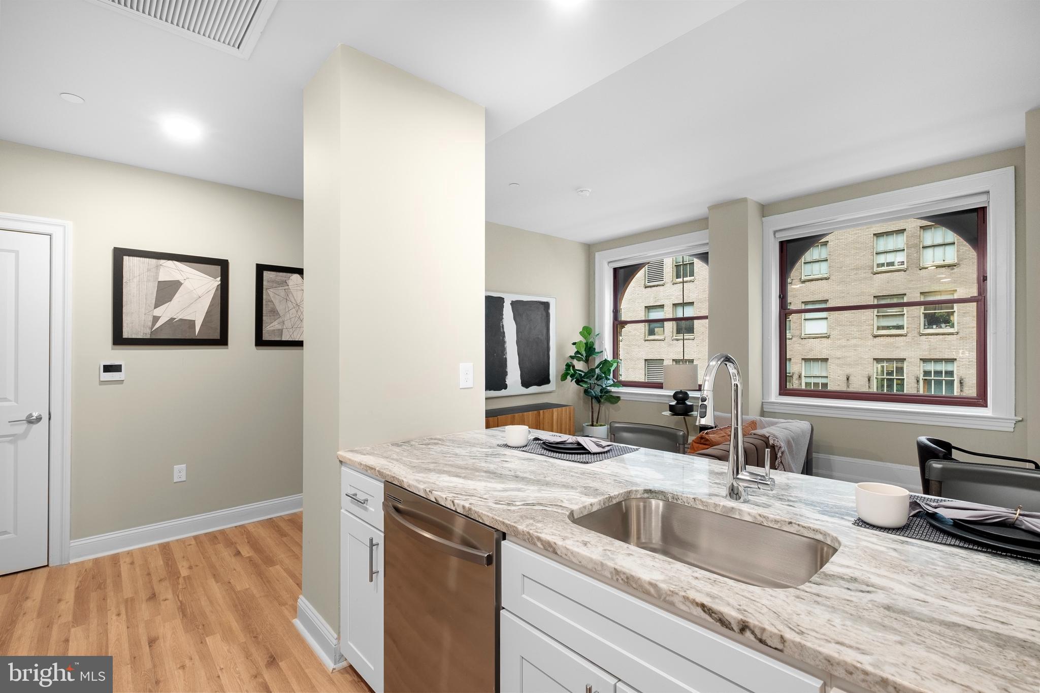 1420-22 Chestnut Street, Unit 604 Philadelphia, PA 19102 - Photo 12 of 35 a kitchen with a sink and a wooden floor