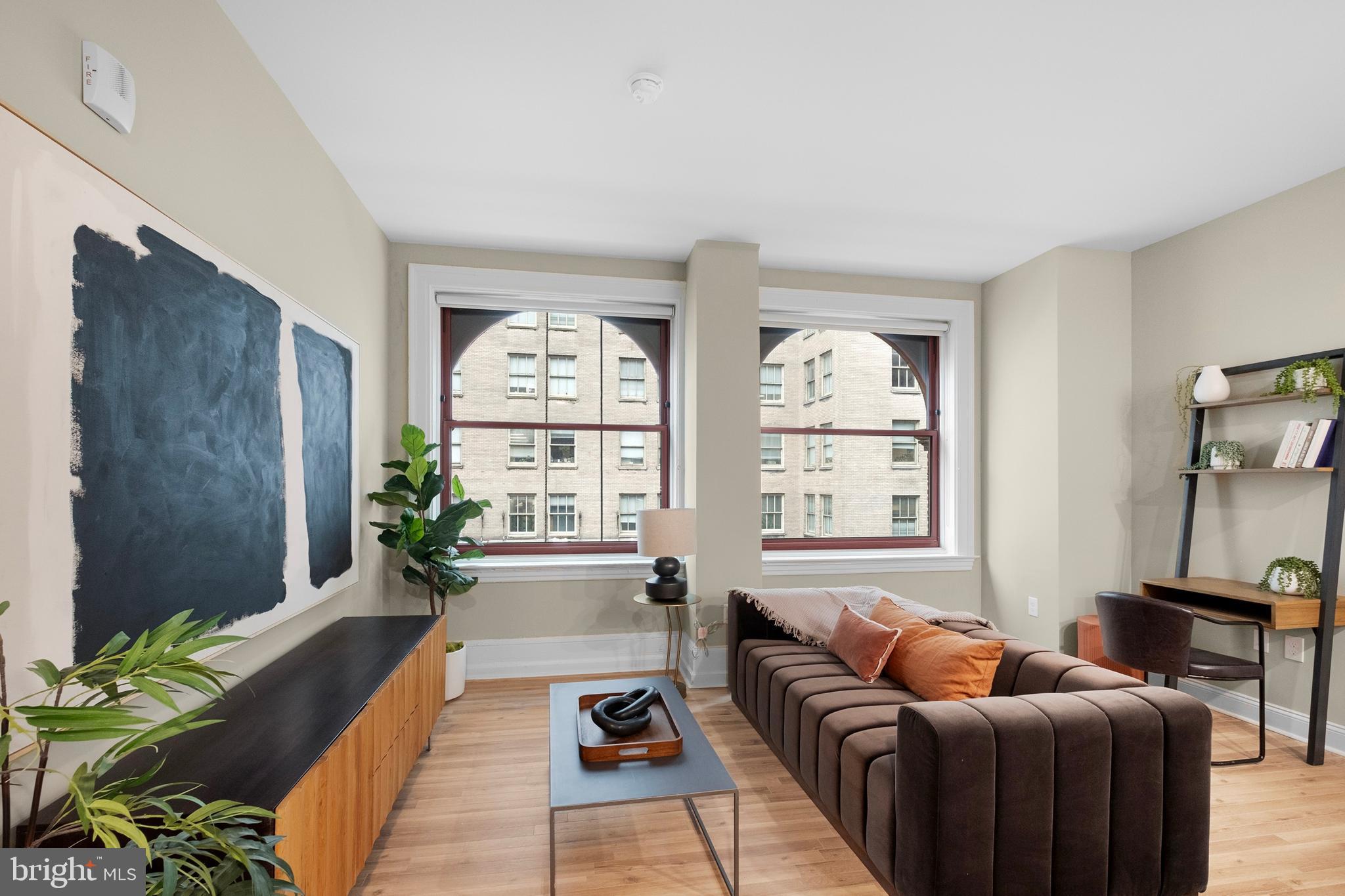 1420-22 Chestnut Street, Unit 604 Philadelphia, PA 19102 - Photo 5 of 35 a living room with furniture and a large window