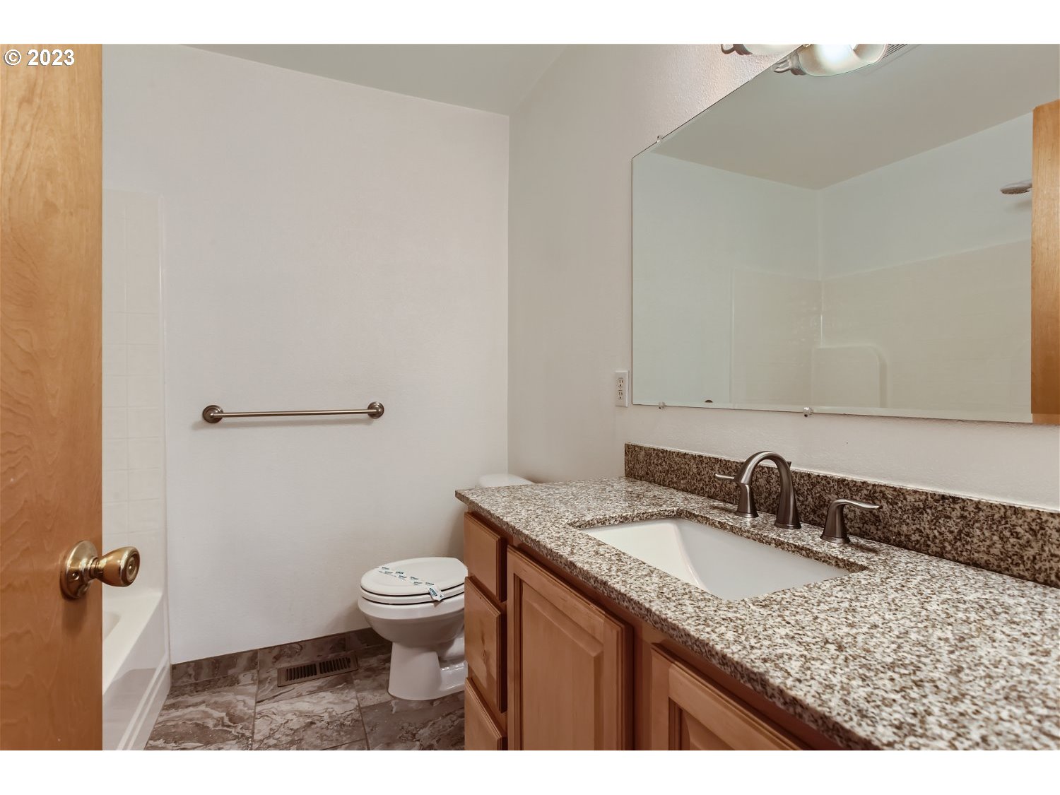 5585 Southwest River Road Hillsboro, OR 97123 - Photo 24 of 29 a bathroom with a granite countertop sink a toilet and a mirror