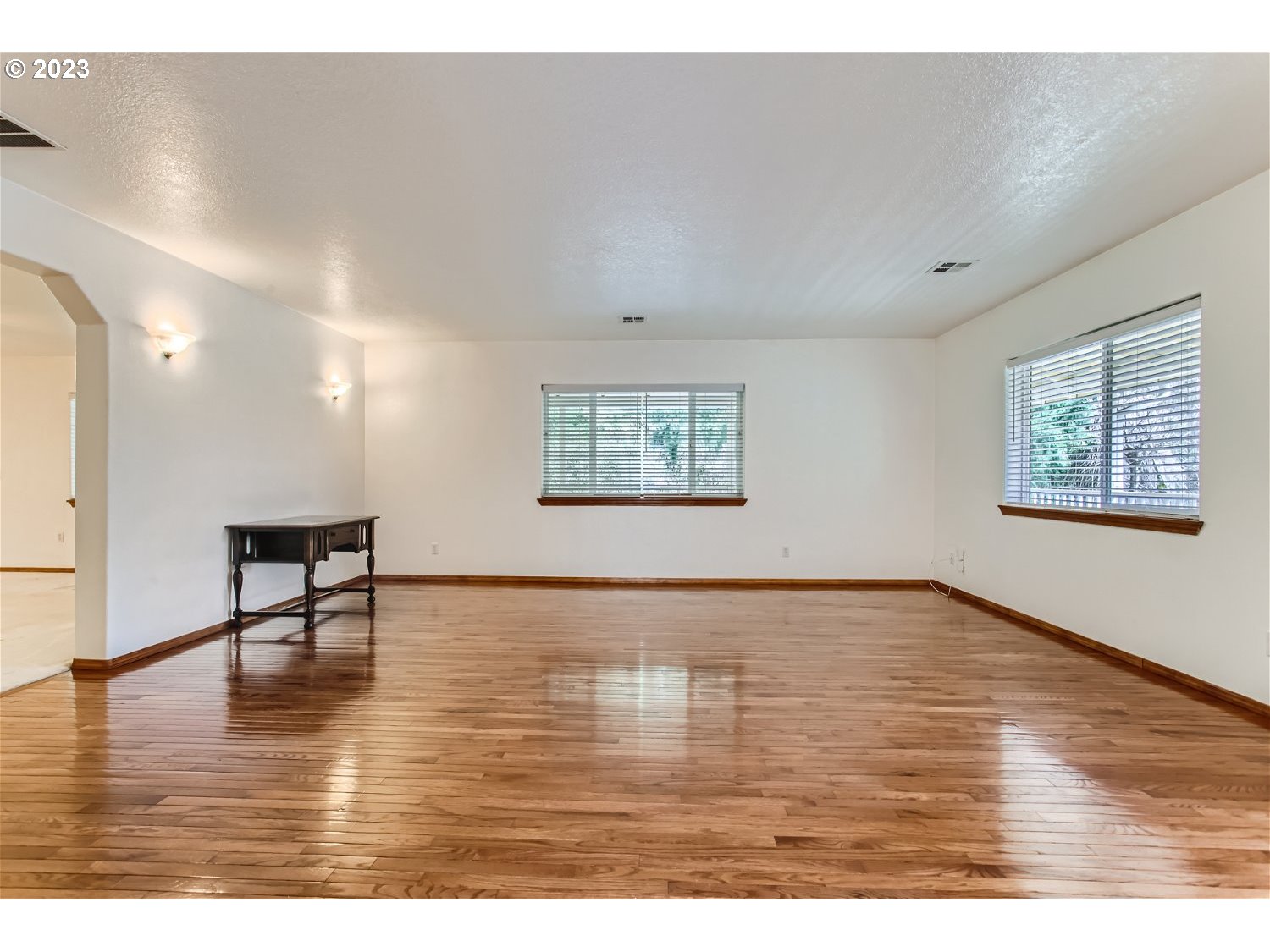 5585 Southwest River Road Hillsboro, OR 97123 - Photo 8 of 29 a view of an empty room with wooden floor and a window