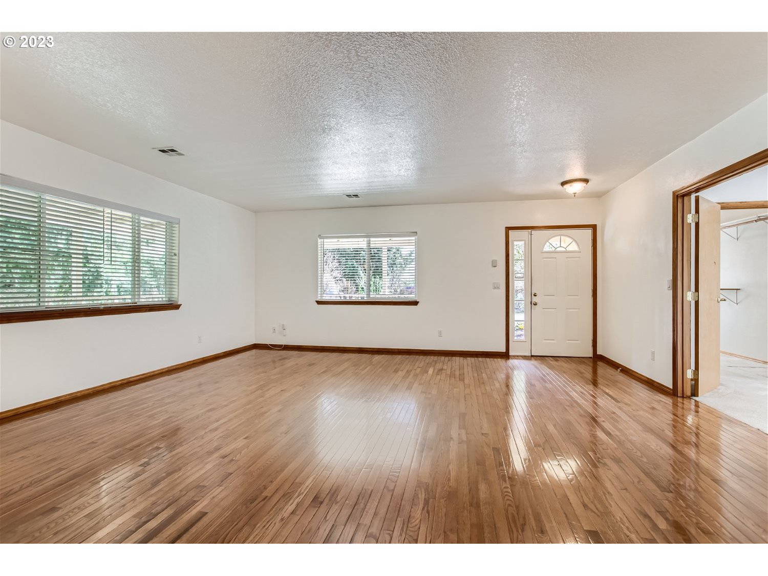5585 Southwest River Road Hillsboro, OR 97123 - Photo 9 of 29 wooden floor in an empty room with a window