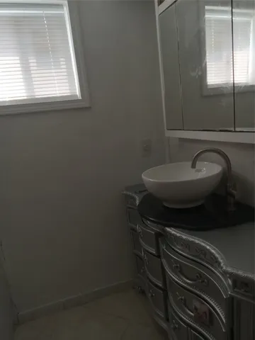 a bathroom with a sink toilet and mirror
