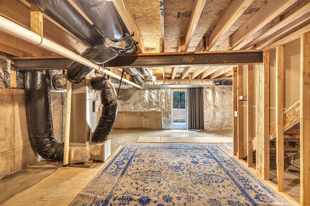 150 Queens Mill Court Pendleton, SC 29670 - Photo 27 of 37 Unfinished basement with exposed beams and a walk-out door offering expansion possibilities.