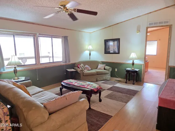 a bedroom with furniture and a wooden floor