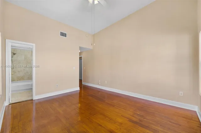 a bathroom with a granite countertop sink a toilet and bathtub