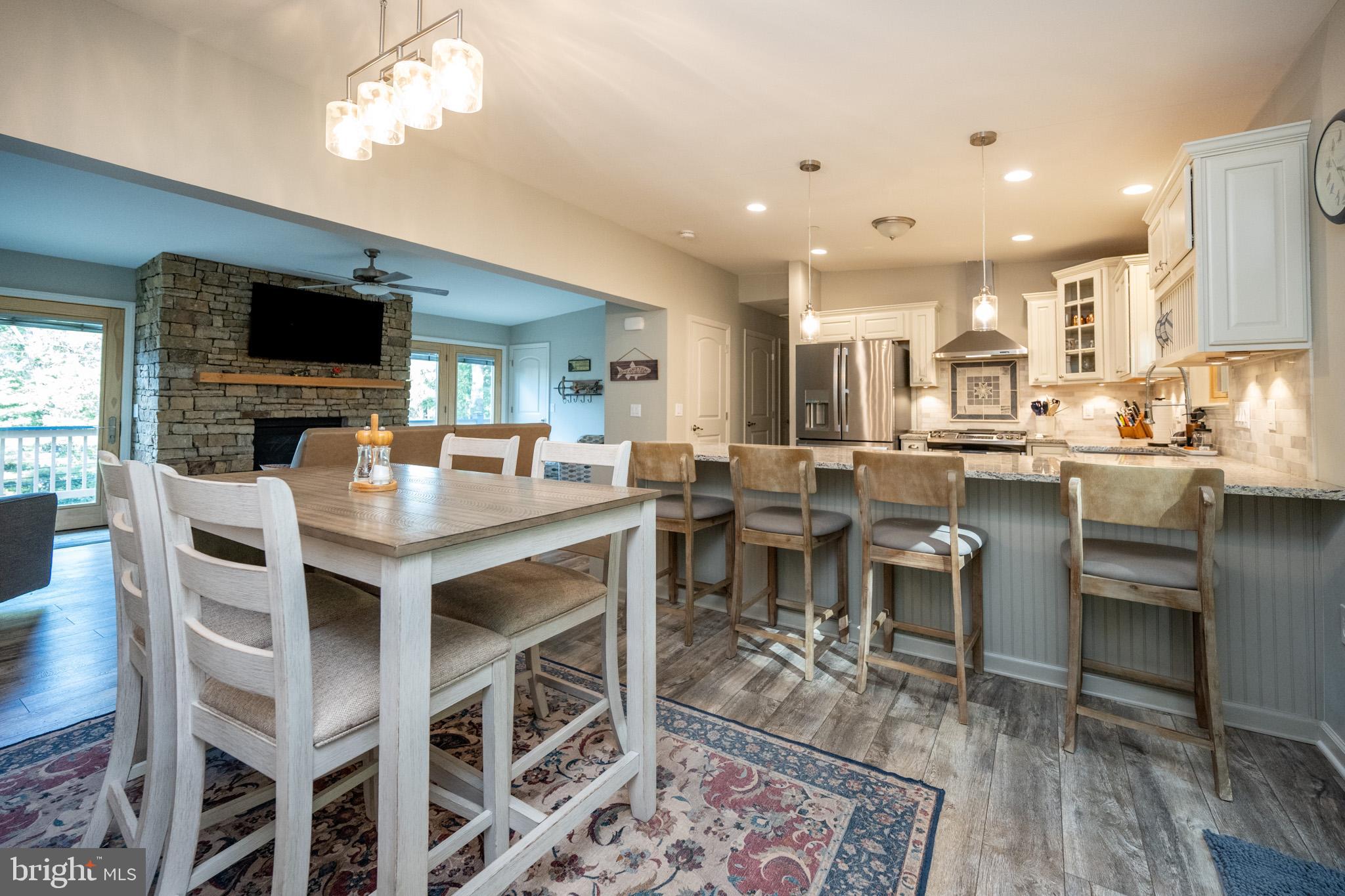 1488 Marsh Hill Road McHenry, MD 21541 - Photo 14 of 64 a kitchen with a dining table chairs and flat screen tv