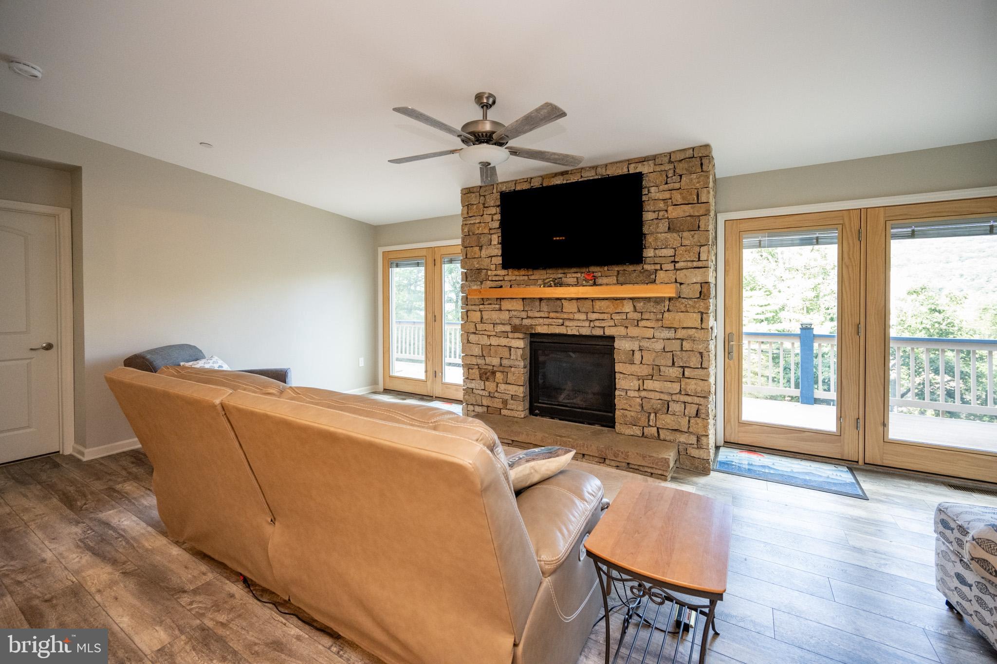 1488 Marsh Hill Road McHenry, MD 21541 - Photo 15 of 64 a living room with furniture a flat screen tv and a fireplace