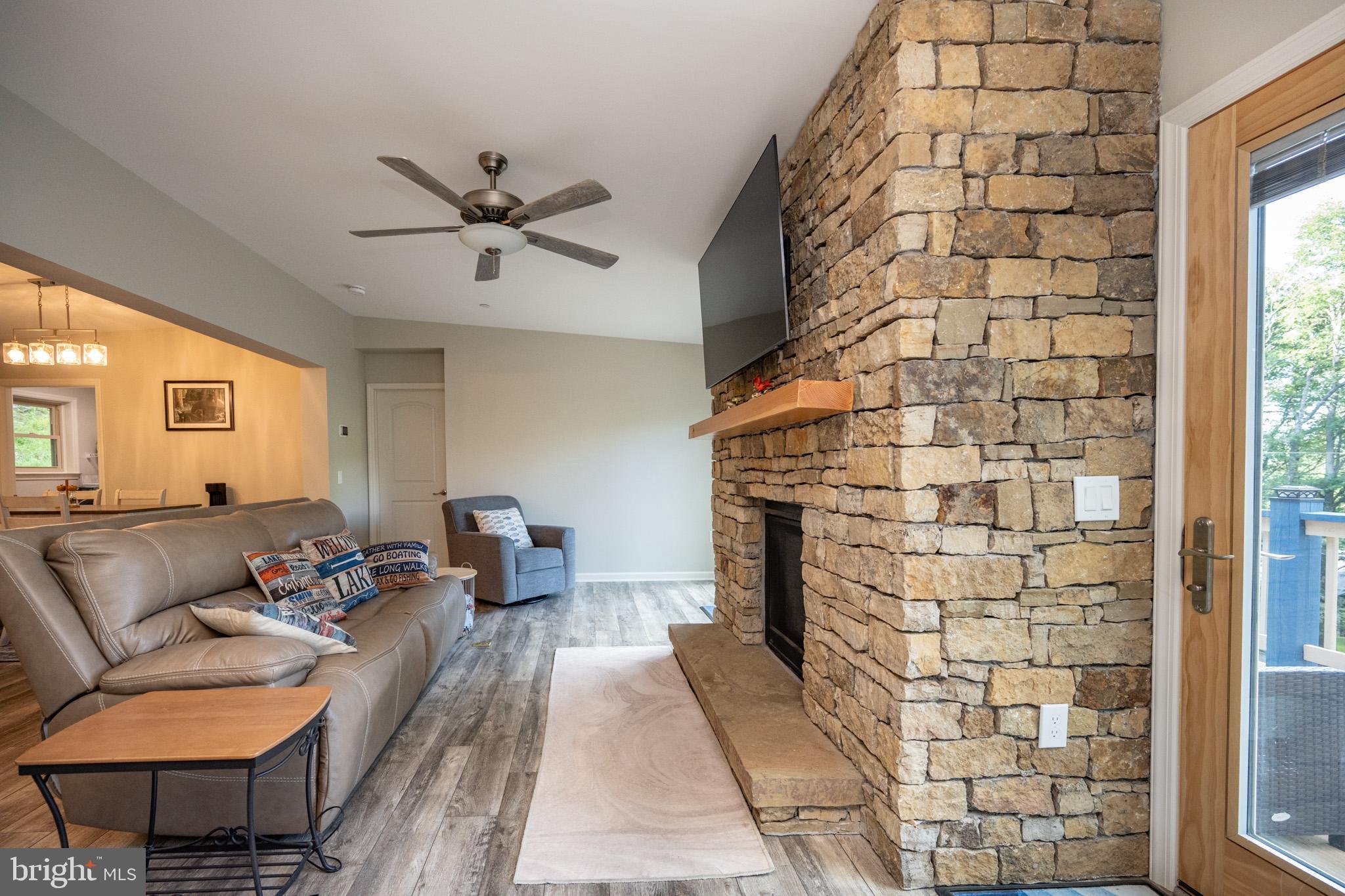1488 Marsh Hill Road McHenry, MD 21541 - Photo 16 of 64 a living room with a couch and a chandelier