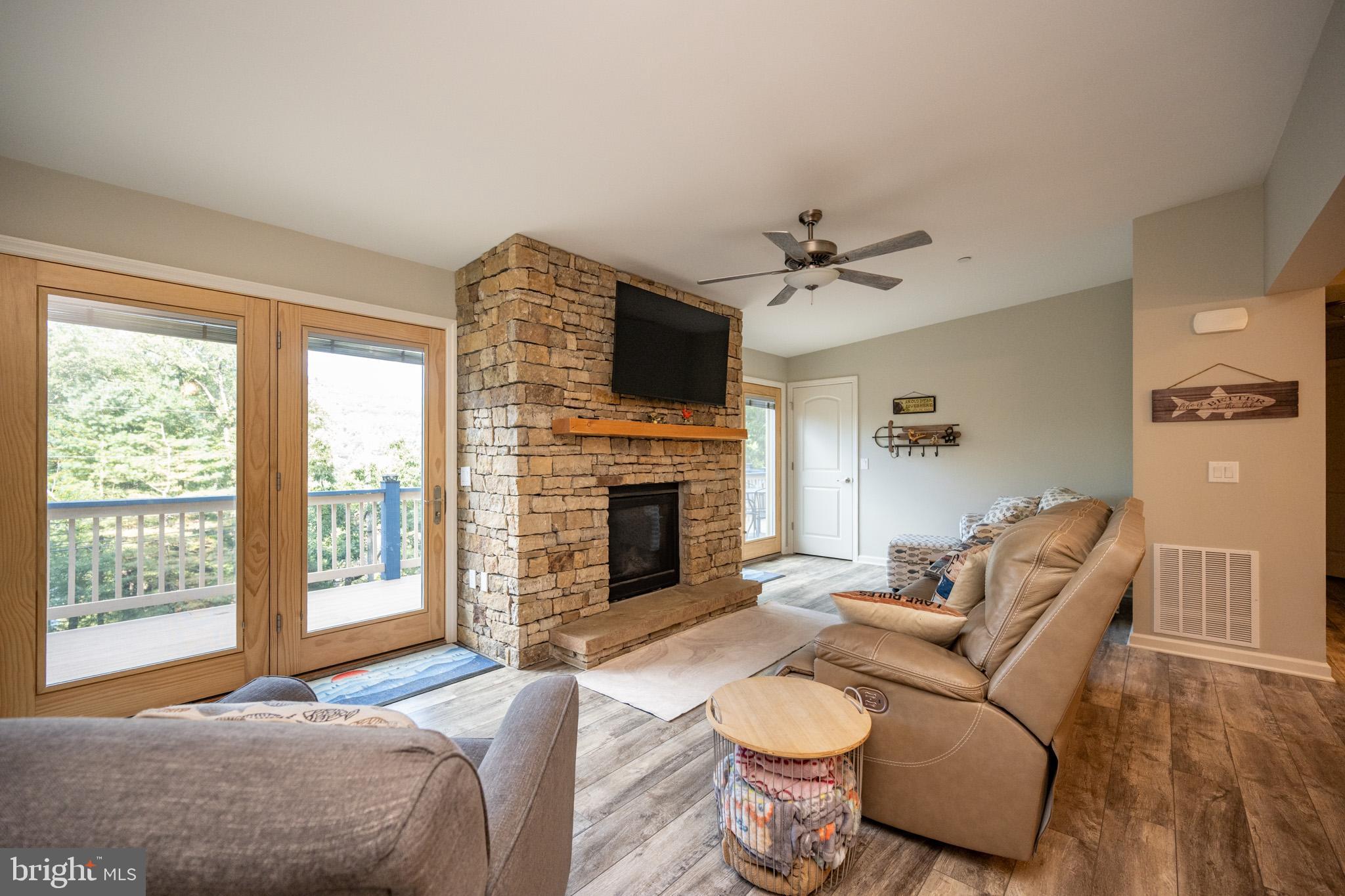 1488 Marsh Hill Road McHenry, MD 21541 - Photo 19 of 64 a living room with furniture a fireplace and a flat screen tv