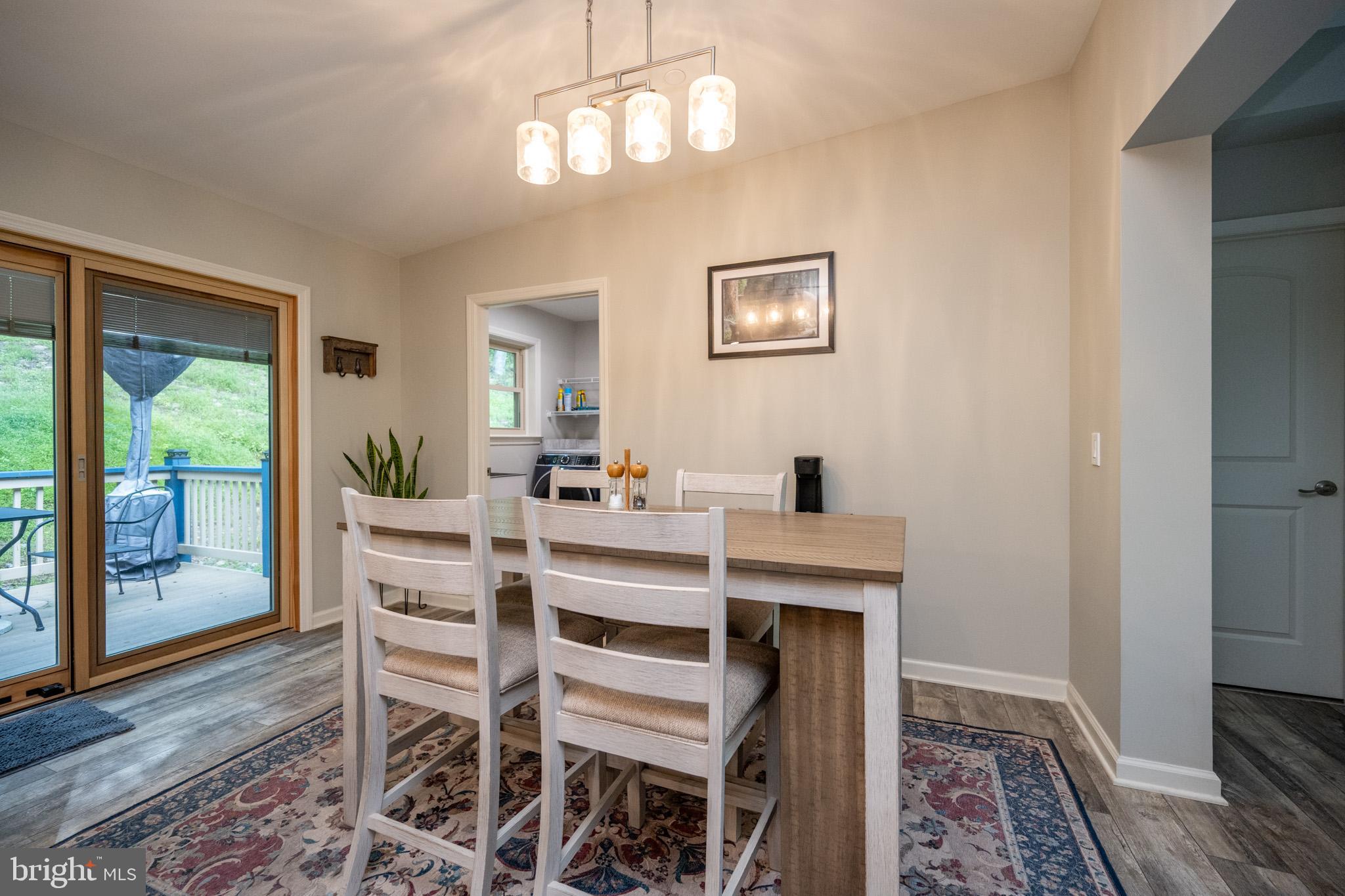 1488 Marsh Hill Road McHenry, MD 21541 - Photo 20 of 64 a view of a dining room with furniture wooden floor and a chandelier