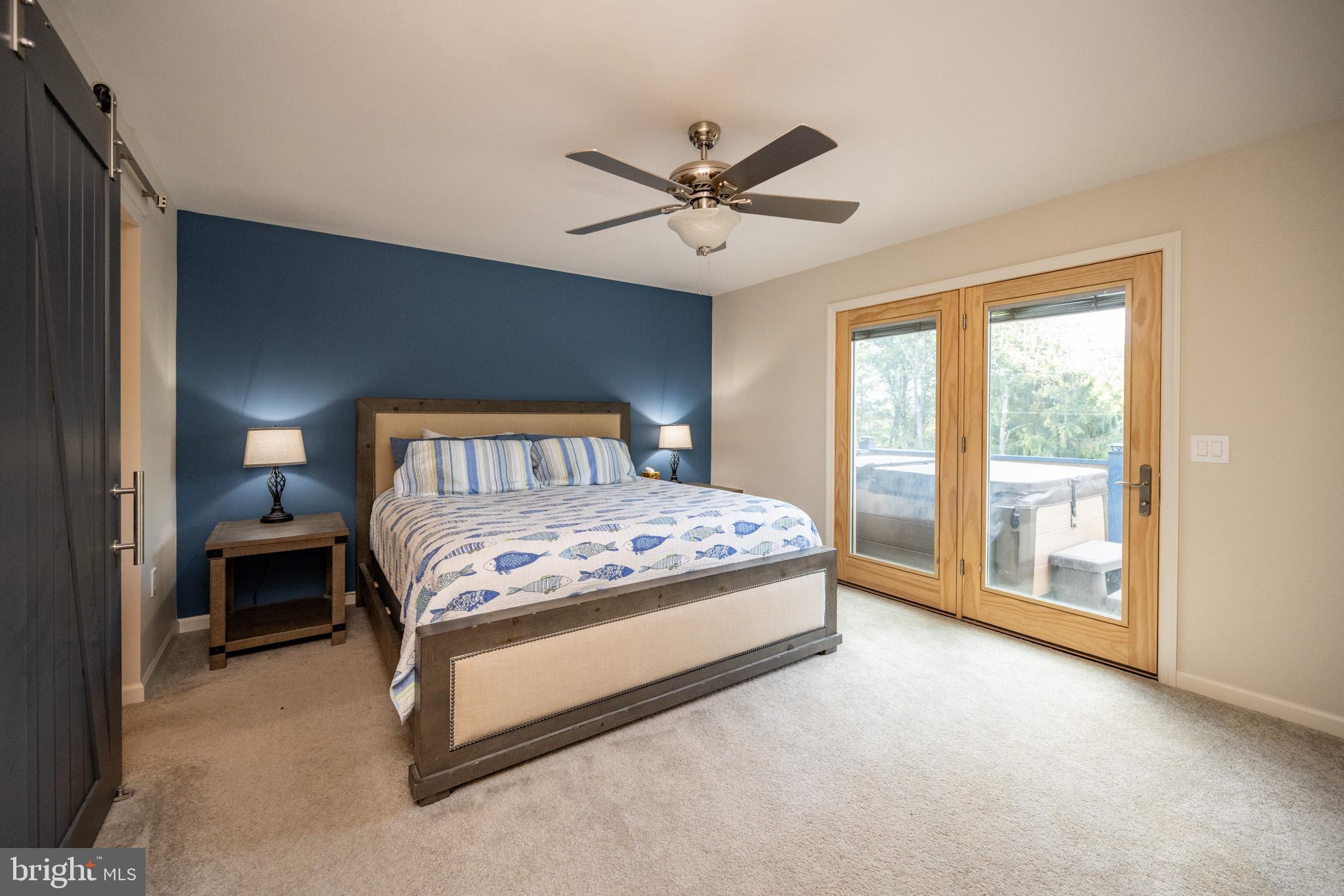 1488 Marsh Hill Road McHenry, MD 21541 - Photo 23 of 64 a bedroom with a large bed and a chandelier fan