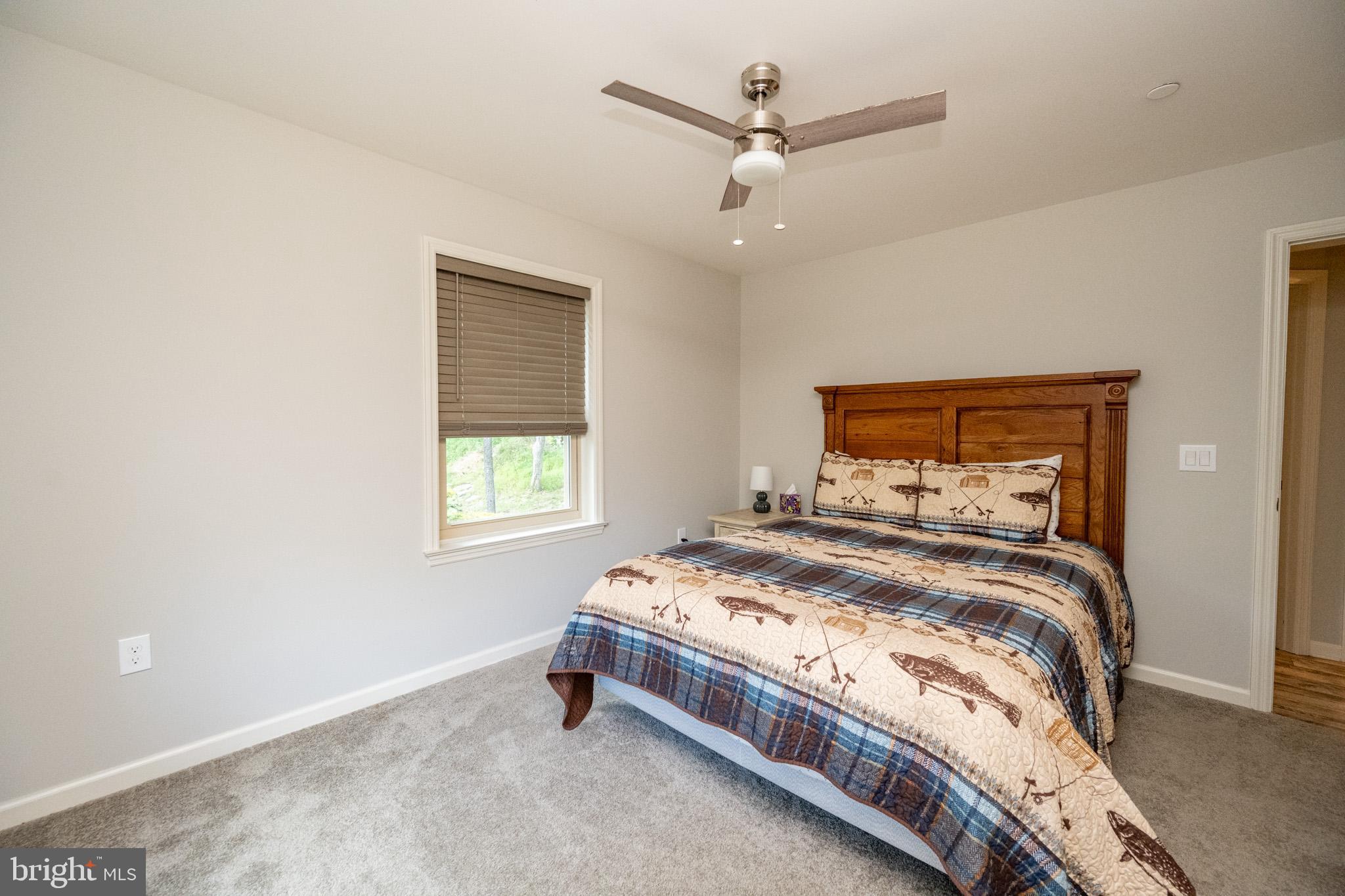 1488 Marsh Hill Road McHenry, MD 21541 - Photo 34 of 64 a bedroom with a bed and a chandelier