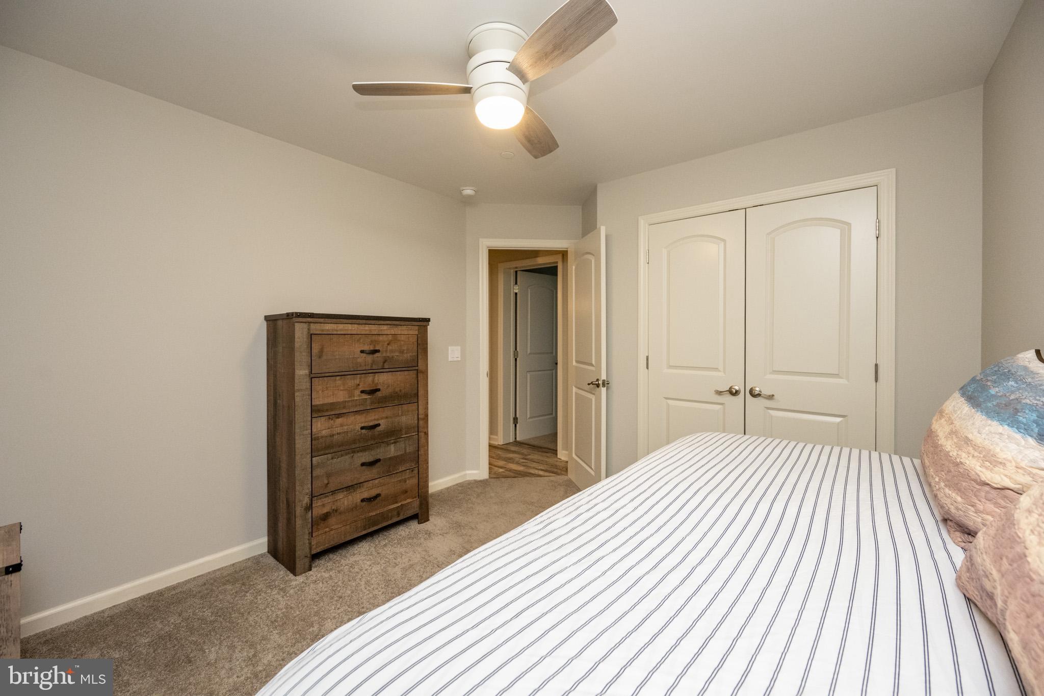 1488 Marsh Hill Road McHenry, MD 21541 - Photo 49 of 64 a bedroom with a bed and a chandelier