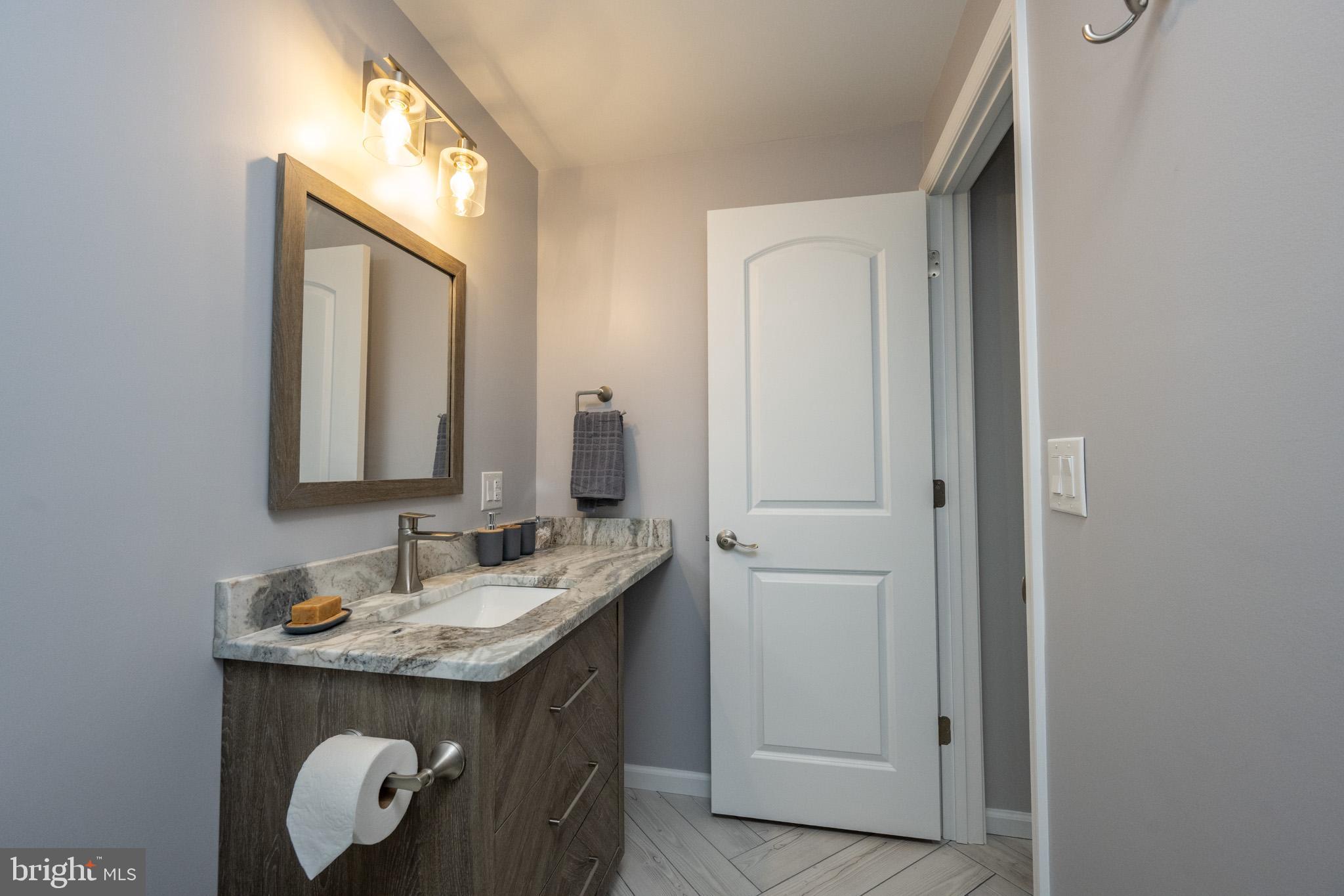 1488 Marsh Hill Road McHenry, MD 21541 - Photo 52 of 64 a bathroom with a granite countertop sink and a mirror
