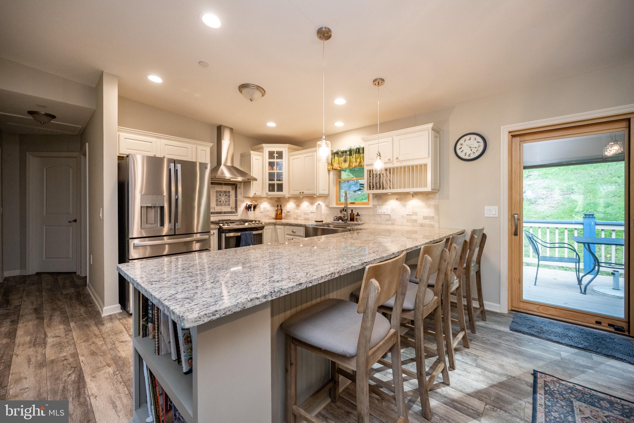 1488 Marsh Hill Road McHenry, MD 21541 - Photo 10 of 64 a kitchen with granite countertop center island and stainless steel appliances