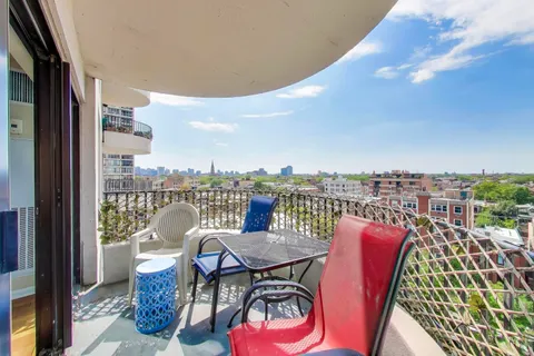 a view of a chairs and table in the balcony