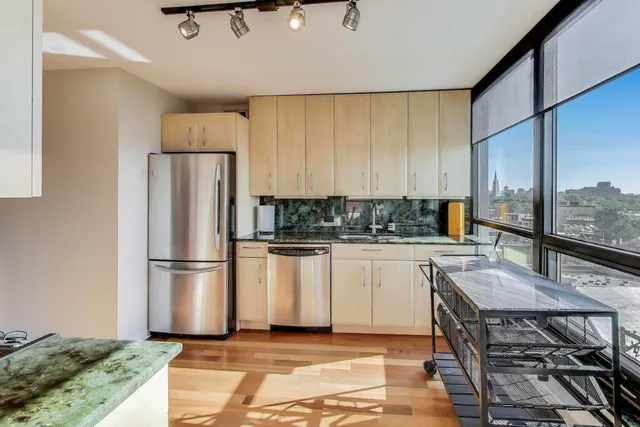 a kitchen with stainless steel appliances a stove a refrigerator and a refrigerator