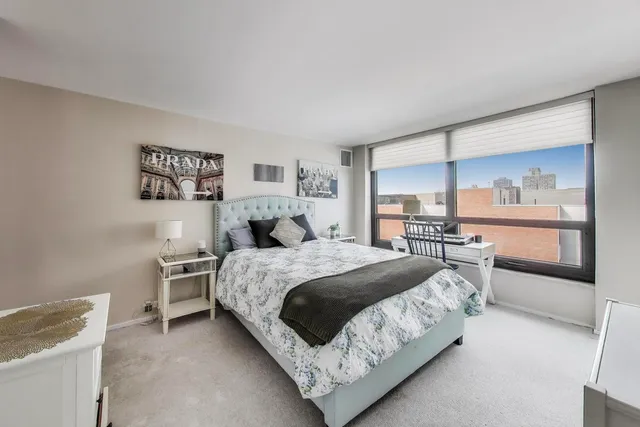 a bedroom with a bed and a window