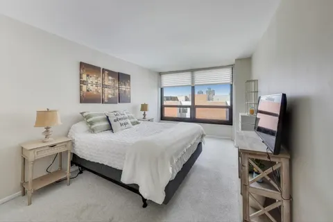 a bedroom with a bed and a tv