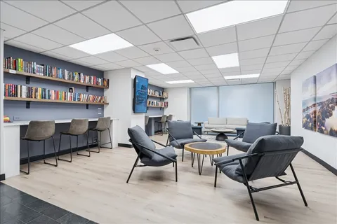 a kitchen with stainless steel appliances granite countertop a sink a stove top oven a chimney and a refrigerator