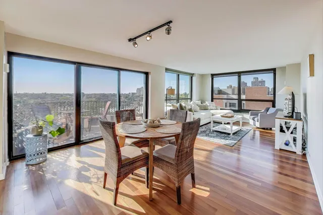 a dining room with furniture window and wooden floor