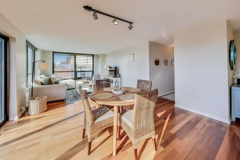 a view of a dining room with furniture and wooden floor