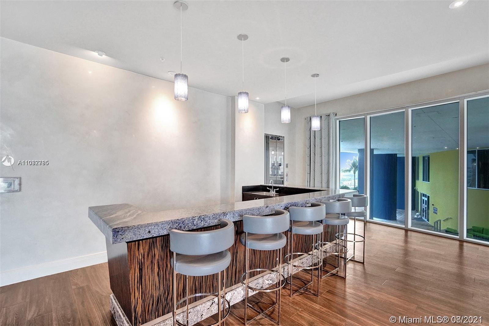 185 Southwest 7th Street, Unit 3502 Miami, FL 33130 - Photo 5 of 15 a view of a dining room with furniture and wooden floor