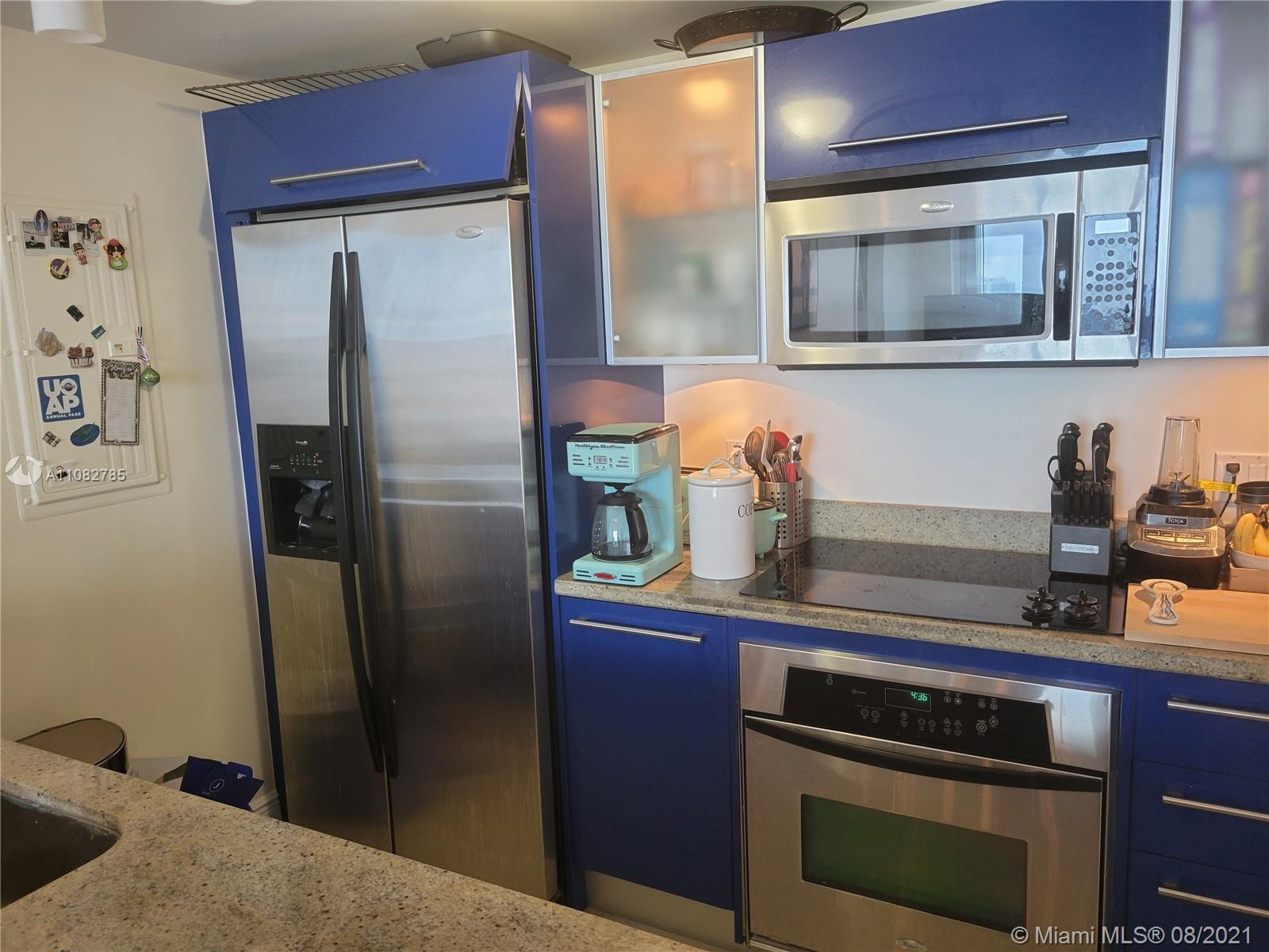 185 Southwest 7th Street, Unit 3502 Miami, FL 33130 - Photo 8 of 15 a kitchen with stainless steel appliances a refrigerator and cabinets