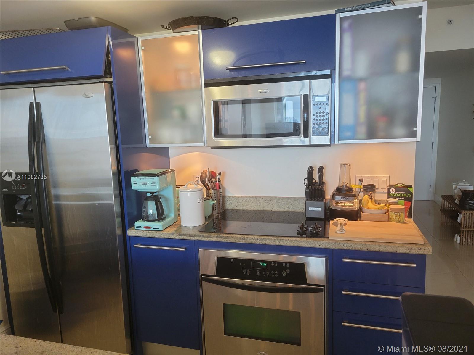 185 Southwest 7th Street, Unit 3502 Miami, FL 33130 - Photo 9 of 15 a kitchen with stainless steel appliances granite countertop a refrigerator and a stove