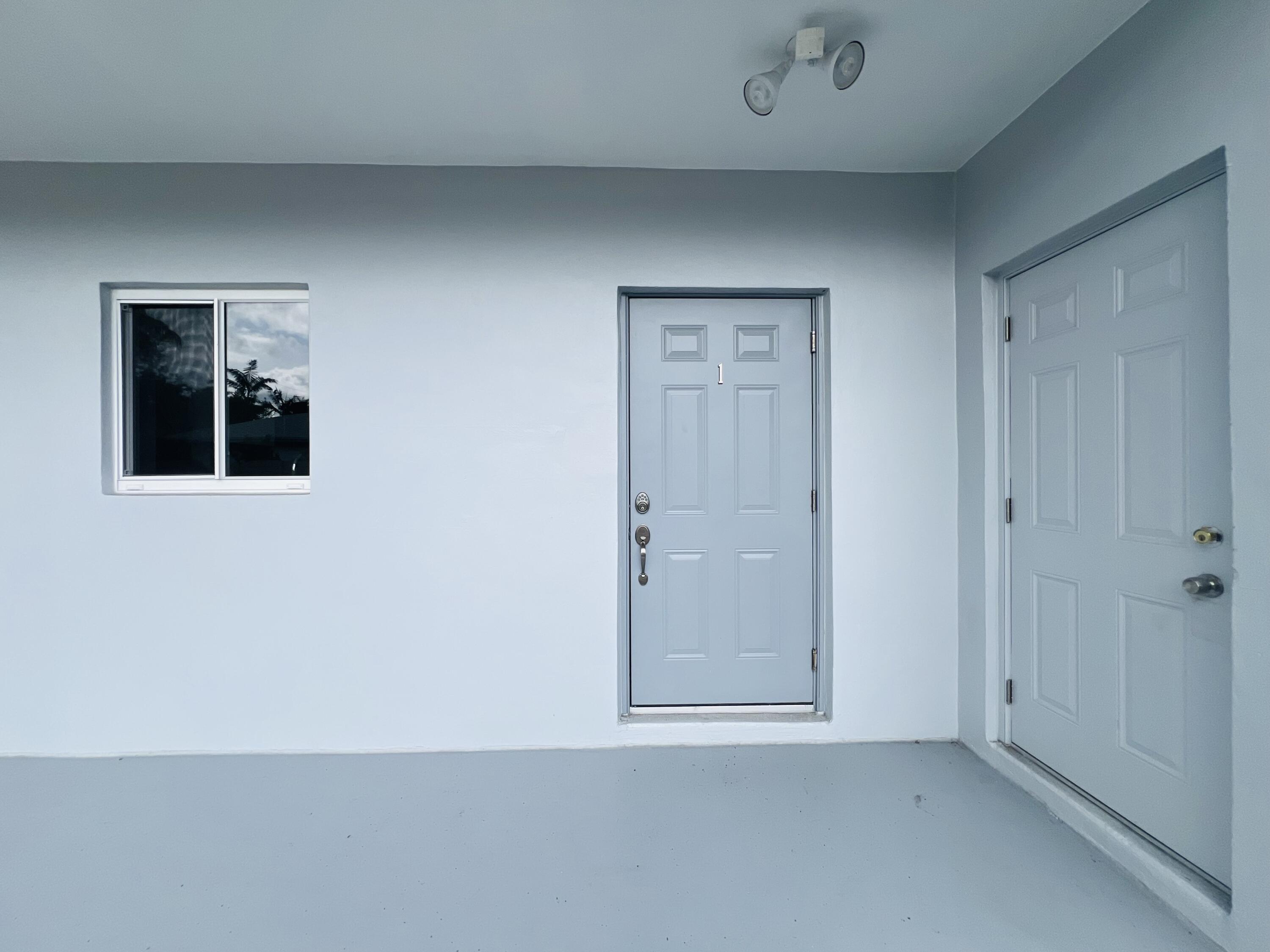 206 Southeast 1st Avenue, Unit 1 Delray Beach, FL 33444 - Photo 9 of 11 an empty room with windows