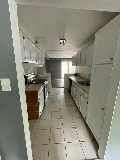 56 Wooded Court Calverton, NY 11933 - Photo 2 of 10 a kitchen with stainless steel appliances granite countertop a sink stove and cabinets