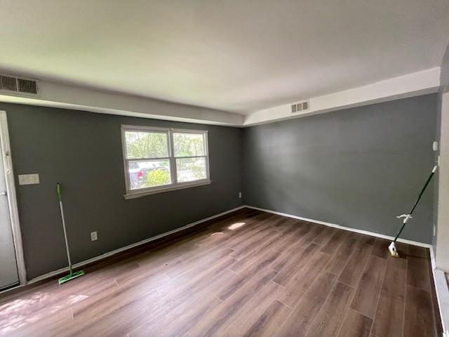 56 Wooded Court Calverton, NY 11933 - Photo 3 of 10 an empty room with wooden floor and windows
