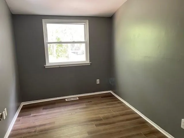 a view of a room with wooden floor and stairs