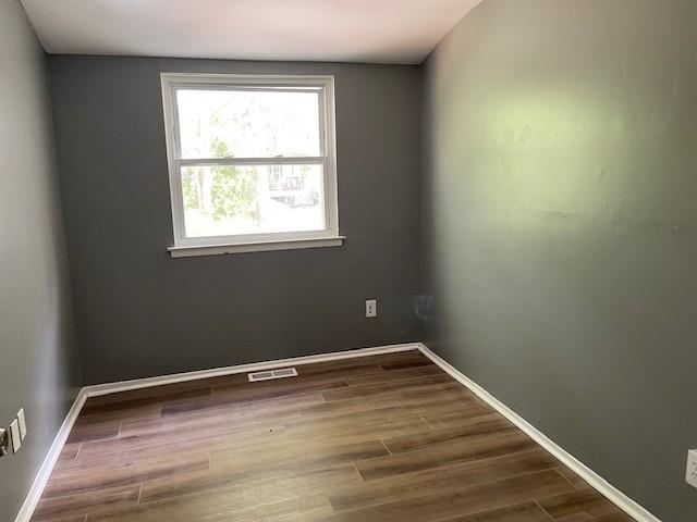 56 Wooded Court Calverton, NY 11933 - Photo 9 of 10 a view of a room with wooden floor and small window