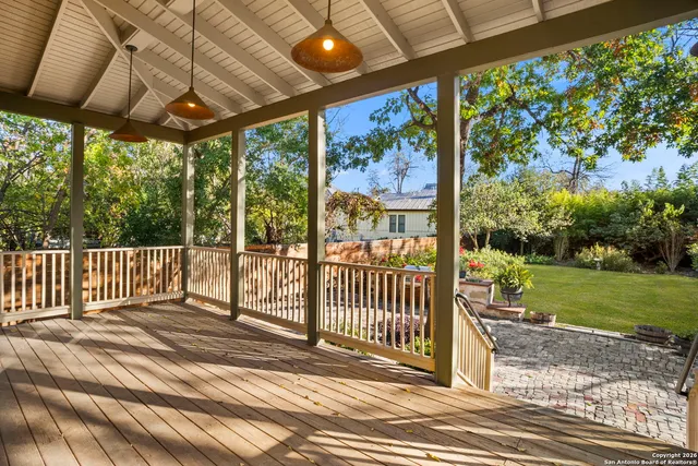 a view of a porch with wooden floor and yard