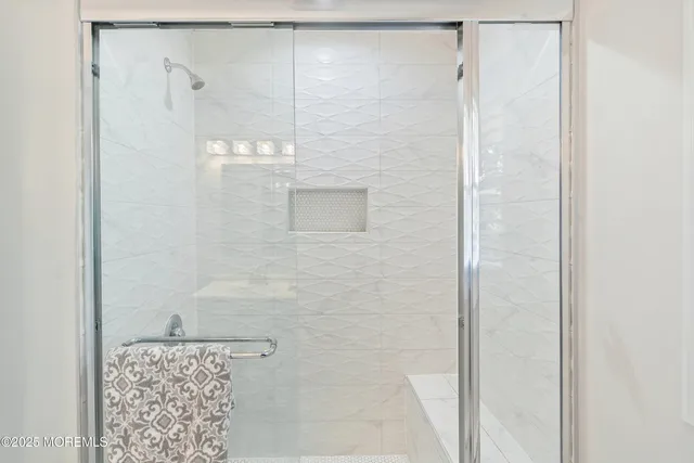 a view of a livingroom with wooden floor and a flat screen tv