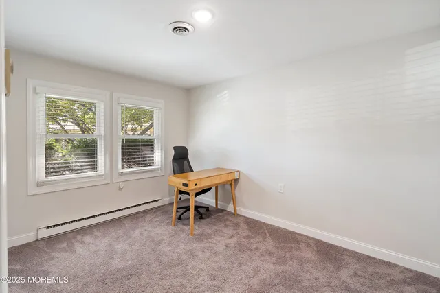 an aerial view of a house with a garden and lake view