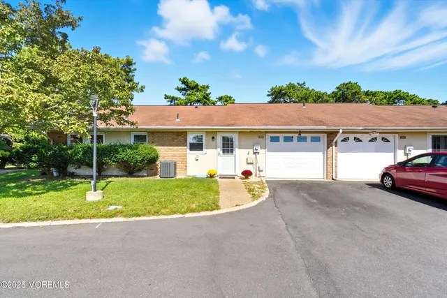 a couple of cars parked in front of a house