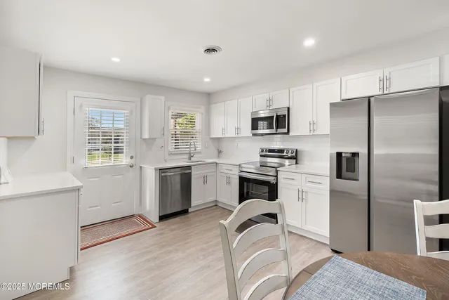 a kitchen with a sink stainless steel appliances and cabinets