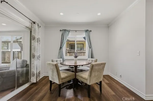 a kitchen with a table chairs stove and cabinets