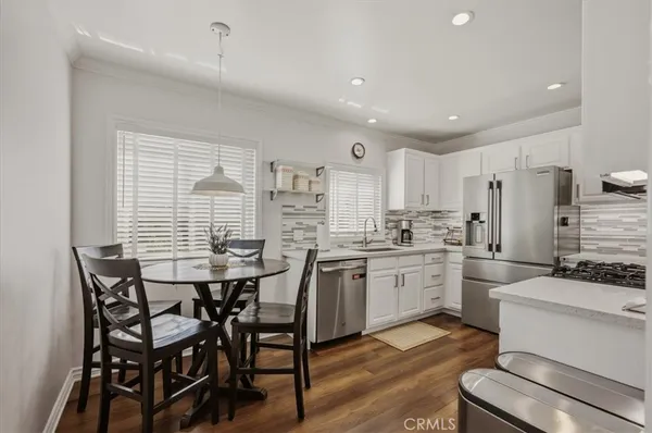 a kitchen with stainless steel appliances a refrigerator stove and sink