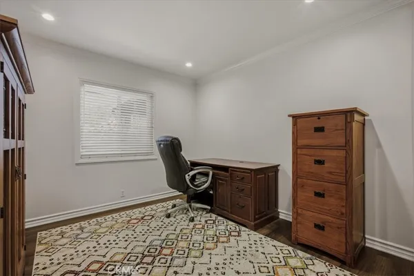 a view of walk in closet with window and entryway