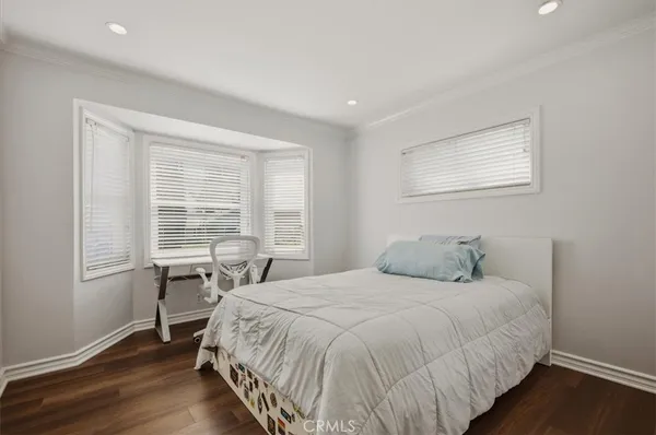 a bedroom with a bed and a chair