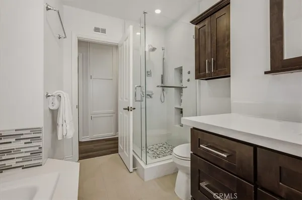 a view of a room with wooden floor and windows