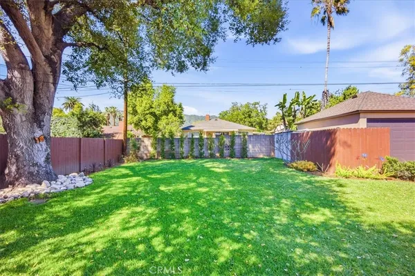 a view of backyard with swimming pool and furniture