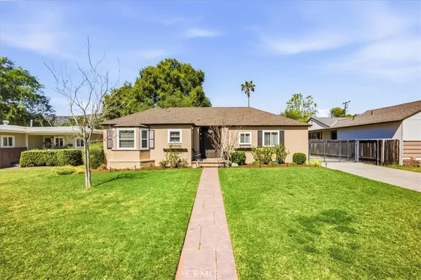 a front view of a house with a garden