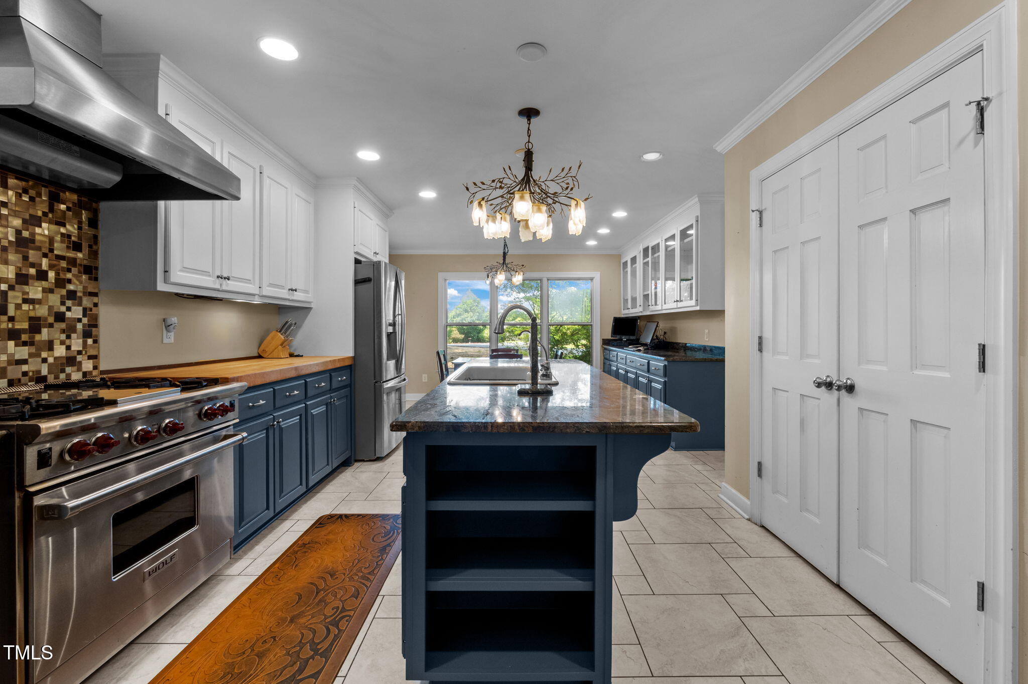 4811 New Sharon Church Road Hillsborough, NC 27278 - Photo 28 of 84 a kitchen with kitchen island granite countertop a sink stainless steel appliances and cabinets