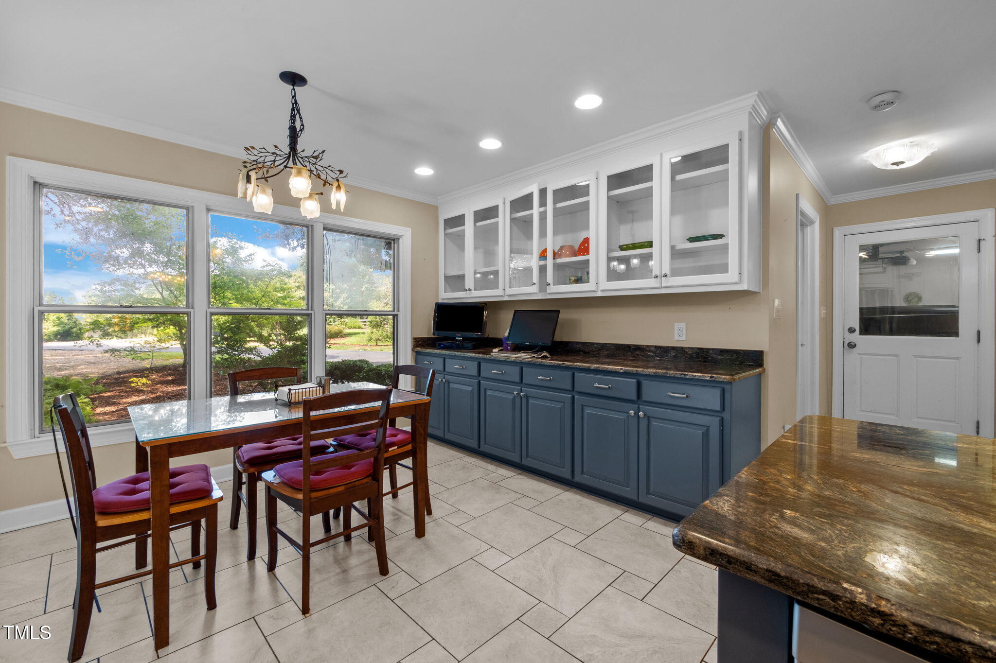 4811 New Sharon Church Road Hillsborough, NC 27278 - Photo 32 of 84 a kitchen with a stove a kitchen island a dining table and chairs with wooden floor